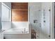 This bathroom features a soaking tub, separate shower, and modern tile work at 19029 E Mary Ann Way, Queen Creek, AZ 85142