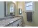 Bathroom featuring a vanity with granite countertop, framed mirror, and natural light from the window at 19029 E Mary Ann Way, Queen Creek, AZ 85142
