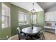 Breakfast nook with green walls, large windows, pendant lighting and dining table at 19029 E Mary Ann Way, Queen Creek, AZ 85142