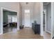 Foyer with wood-look tile floors, a bench, dresser, and an office visible through a doorway at 19029 E Mary Ann Way, Queen Creek, AZ 85142