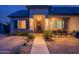 Inviting front entrance with a decorative door, stone accents, and a well-lit walkway at 19029 E Mary Ann Way, Queen Creek, AZ 85142