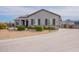 Single-story home boasting stone accents, desert landscaping, shutters, and a long concrete driveway at 19029 E Mary Ann Way, Queen Creek, AZ 85142