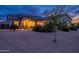 Charming single-story home featuring beautiful landscaping and a welcoming covered entryway at dusk at 19029 E Mary Ann Way, Queen Creek, AZ 85142