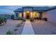 Well-maintained front exterior with a charming covered porch, desert landscaping and stone accents at 19029 E Mary Ann Way, Queen Creek, AZ 85142