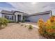 Welcoming single-story home with desert landscaping and a cozy front porch seating area at 19029 E Mary Ann Way, Queen Creek, AZ 85142