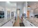 Bright kitchen features white cabinets, granite countertops and stainless steel appliances at 19029 E Mary Ann Way, Queen Creek, AZ 85142
