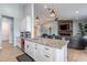 Bright kitchen with granite counters, white cabinets, stainless appliances, and open access to living area at 19029 E Mary Ann Way, Queen Creek, AZ 85142