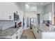 Modern kitchen features granite counters, white cabinetry, stainless appliances, and pantry at 19029 E Mary Ann Way, Queen Creek, AZ 85142
