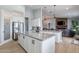 Open kitchen features granite counters, white cabinets, stainless appliances, and large island at 19029 E Mary Ann Way, Queen Creek, AZ 85142