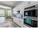 Close-up of kitchen appliances, white cabinets and granite countertops at 19029 E Mary Ann Way, Queen Creek, AZ 85142