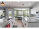 Open kitchen with granite countertops, stainless steel sink, and dining area at 19029 E Mary Ann Way, Queen Creek, AZ 85142