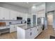 Bright kitchen with white cabinets, stainless appliances, granite countertops, and spacious island at 19029 E Mary Ann Way, Queen Creek, AZ 85142