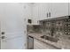 Laundry room featuring stylish tile backsplash and utility sink at 19029 E Mary Ann Way, Queen Creek, AZ 85142