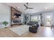 Living room features modern fireplace, TV, comfy seating, ceiling fan, and views to the outdoors at 19029 E Mary Ann Way, Queen Creek, AZ 85142
