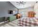 The main bedroom boasts a wood accent wall, ceiling fan, and neutral color palette at 19029 E Mary Ann Way, Queen Creek, AZ 85142