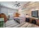The main bedroom offers a wood accent wall, ceiling fan, and neutral color palette at 19029 E Mary Ann Way, Queen Creek, AZ 85142