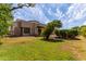 Lush backyard features mature trees, green grass, and a charming desert-style landscape at 1954 N Calle Maderas --, Mesa, AZ 85213
