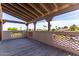 Charming covered balcony shows wood flooring and patterned concrete railing with treetop views at 1954 N Calle Maderas --, Mesa, AZ 85213