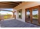 Spacious balcony showcases a wooden ceiling and flooring with views of the clear blue sky at 1954 N Calle Maderas --, Mesa, AZ 85213