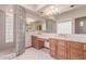 Bright bathroom features a glass block shower and vanity with double sinks at 1954 N Calle Maderas --, Mesa, AZ 85213