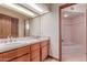 An expansive bathroom with double sinks, a full-width mirror, and a separate tub with a tiled shower at 1954 N Calle Maderas --, Mesa, AZ 85213