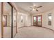 A bright bedroom with plush carpet, a ceiling fan, mirrored closet doors and access to an outdoor balcony at 1954 N Calle Maderas --, Mesa, AZ 85213