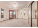Bedroom with plush carpet, a ceiling fan, sliding mirrored closet doors and glass paneled exterior doors at 1954 N Calle Maderas --, Mesa, AZ 85213