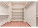 Spacious walk-in closet with built-in shelving and laminate floors at 1954 N Calle Maderas --, Mesa, AZ 85213