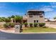 Stunning home exterior with a front yard featuring mature landscaping, stucco facade, and covered second story patio at 1954 N Calle Maderas --, Mesa, AZ 85213