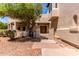Inviting front entrance features a wood door, brick accents, covered porch, and mature landscaping at 1954 N Calle Maderas --, Mesa, AZ 85213