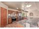 Cozy kitchen features stainless steel appliances, granite countertops, tile floors, and a ceiling fan at 1954 N Calle Maderas --, Mesa, AZ 85213