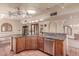 Spacious kitchen with wooden cabinets, tile floors, granite countertops, and stainless steel appliances at 1954 N Calle Maderas --, Mesa, AZ 85213