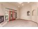 A bright living room with a fireplace, wood floors, and double doors leading to the patio at 1954 N Calle Maderas --, Mesa, AZ 85213