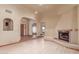 Bright living room showcasing wood floors, a fireplace, arches, and neutral paint at 1954 N Calle Maderas --, Mesa, AZ 85213