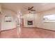 Spacious living room features a brick fireplace and large windows at 1954 N Calle Maderas --, Mesa, AZ 85213