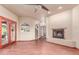 Large living room boasts a brick fireplace, ceiling fan, and access to the backyard at 1954 N Calle Maderas --, Mesa, AZ 85213