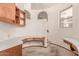 A bright office features built-in wooden cabinets and a desk with a white countertop and plush carpet at 1954 N Calle Maderas --, Mesa, AZ 85213