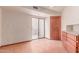 Room with tile flooring, a ceiling fan, an exterior sliding glass door, and wooden cabinets with drawer space at 1954 N Calle Maderas --, Mesa, AZ 85213
