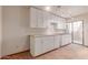 Bright room with white cabinets, countertop space and a sliding glass door leading to the outside at 1954 N Calle Maderas --, Mesa, AZ 85213