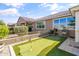 Backyard featuring a putting green, barbecue, and a patio perfect for outdoor entertaining at 20426 N Blazing Sun Rd, Maricopa, AZ 85138