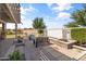 Inviting backyard featuring a water feature, bar, mini-golf, and comfortable seating for outdoor relaxation at 20426 N Blazing Sun Rd, Maricopa, AZ 85138