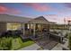 An inviting backyard boasts a putting green, an outdoor kitchen, and a covered patio with lounge seating at 20426 N Blazing Sun Rd, Maricopa, AZ 85138