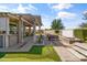 Expansive backyard featuring a putting green, bar, pergola, water feature, and lush landscaping at 20426 N Blazing Sun Rd, Maricopa, AZ 85138