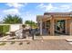 Backyard view highlighting a patio area with a fire feature and covered outdoor living space at 20426 N Blazing Sun Rd, Maricopa, AZ 85138