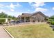 Large backyard with a patio, outdoor kitchen, and a well-maintained lawn at 20426 N Blazing Sun Rd, Maricopa, AZ 85138