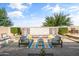 Inviting backyard patio area with comfortable seating, water feature, and lush landscaping at 20426 N Blazing Sun Rd, Maricopa, AZ 85138