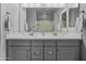 Bathroom featuring double sinks, a large mirror, and modern fixtures at 20426 N Blazing Sun Rd, Maricopa, AZ 85138
