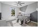 Cozy bedroom features stylish decor, including a comfortable daybed and modern geometric wall design at 20426 N Blazing Sun Rd, Maricopa, AZ 85138