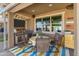 Inviting covered patio with outdoor kitchen, dining table, and comfortable seating area at 20426 N Blazing Sun Rd, Maricopa, AZ 85138