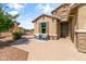 Inviting front porch with two Adirondack chairs, desert landscaping, and stone accents at 20426 N Blazing Sun Rd, Maricopa, AZ 85138